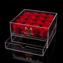 Clear acrylic box with 16 red roses and SoulPetal branding on a black background
