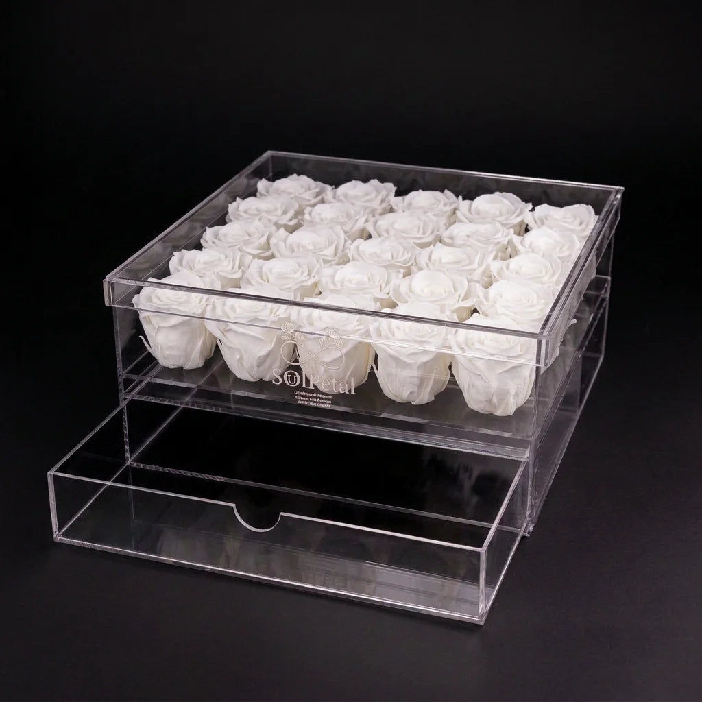Clear acrylic box with 25 white roses on a black background