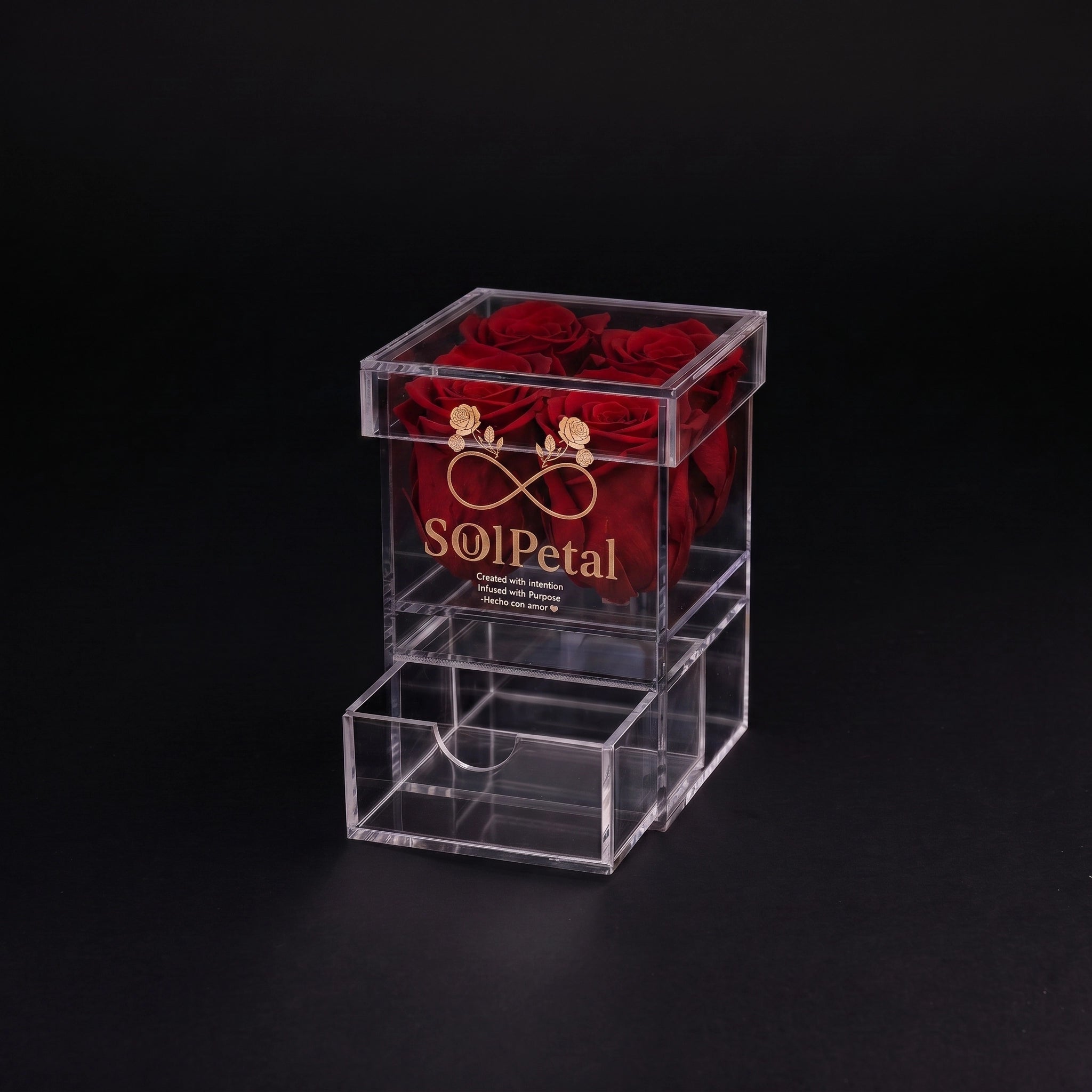 Clear box container with 4 red roses and SoulPetal  branding on a black background