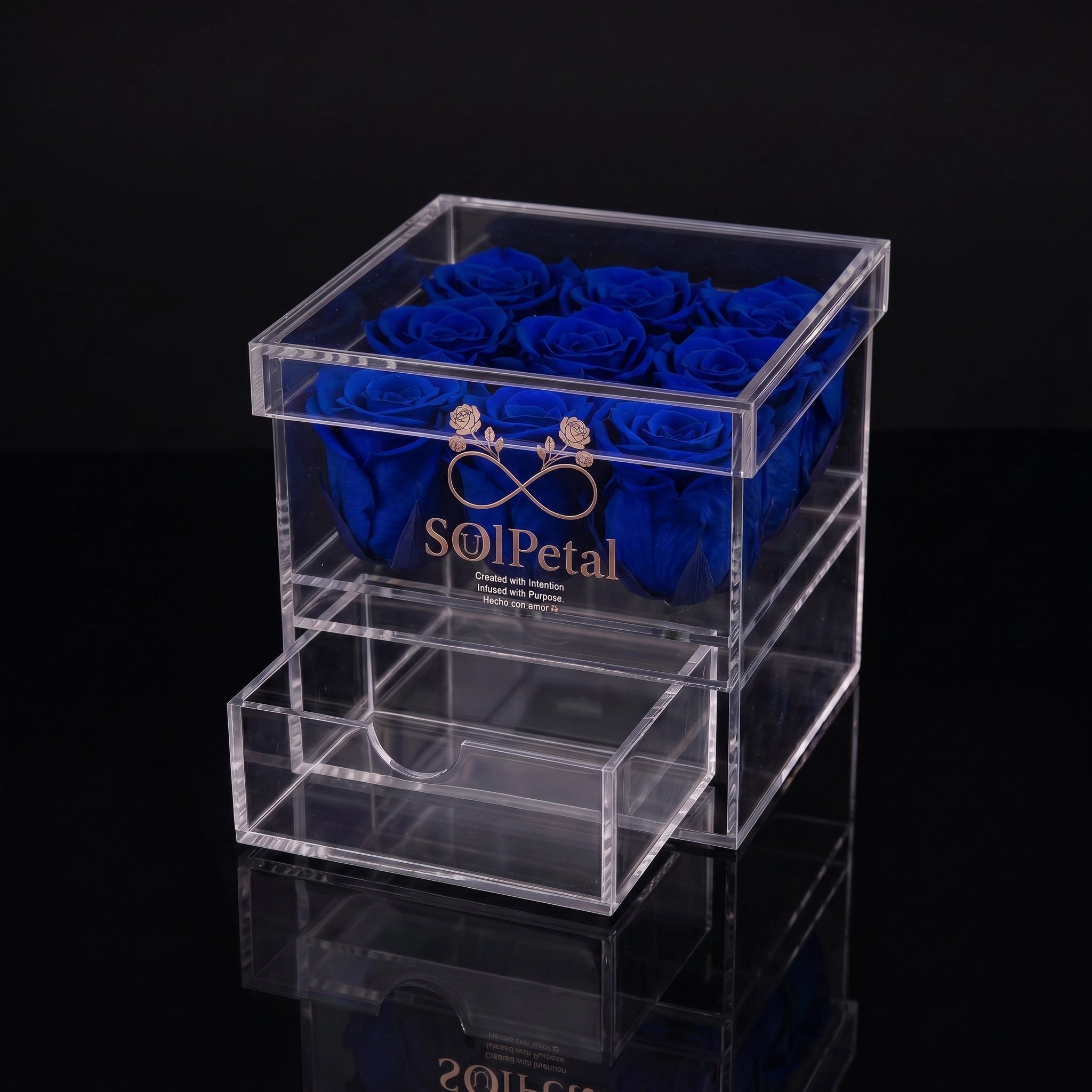 Clear acrylic box with 9 blue preserved roses and SoulPetal branding on a black background