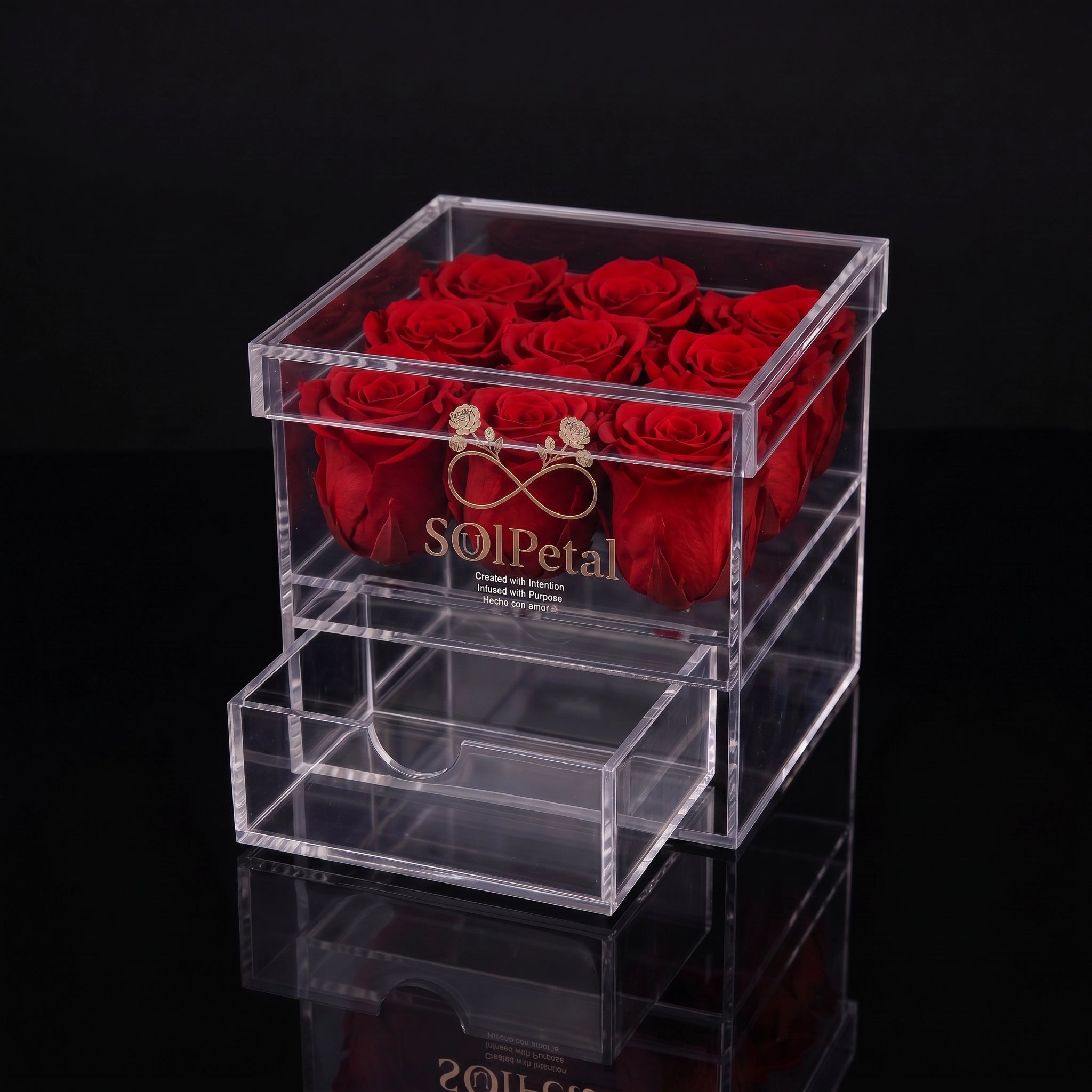 Clear acrylic box with 9 red roses and a gold ring on a black background, featuring the brand SoulPetal .