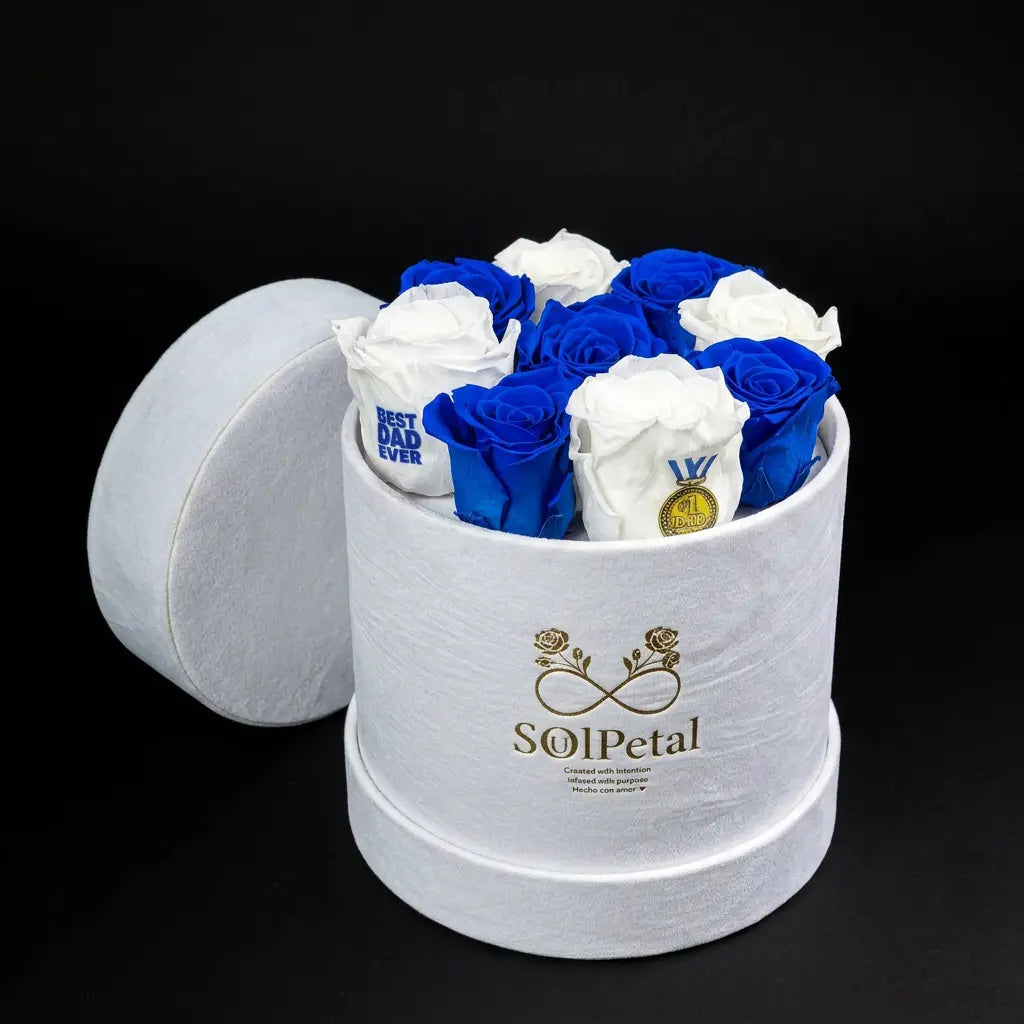 White and blue roses in a white velvet round box with SoulPetal  branding on a black background