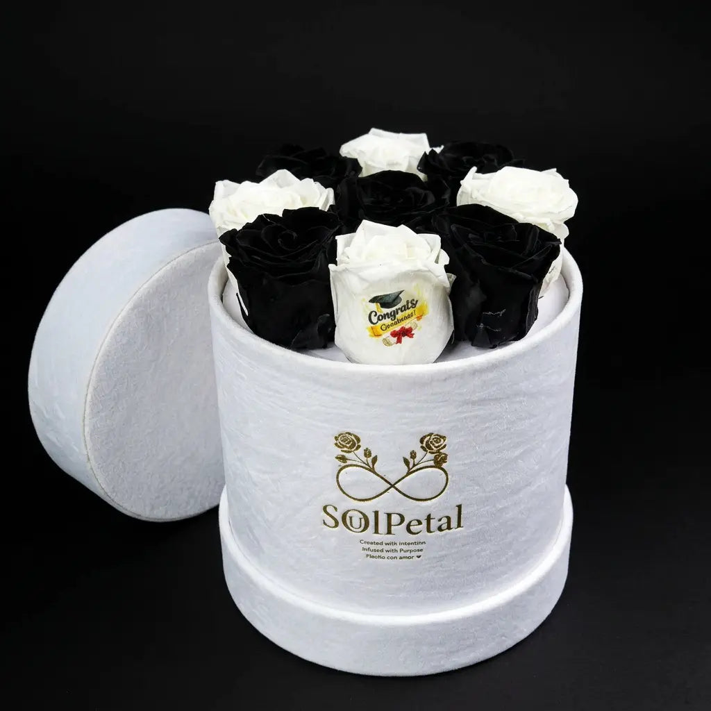 White and black roses in a cylindrical white box with SoulPetal  branding on a black background
