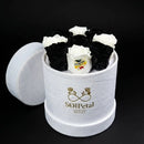 White and black roses in a cylindrical white box with SoulPetal  branding on a black background