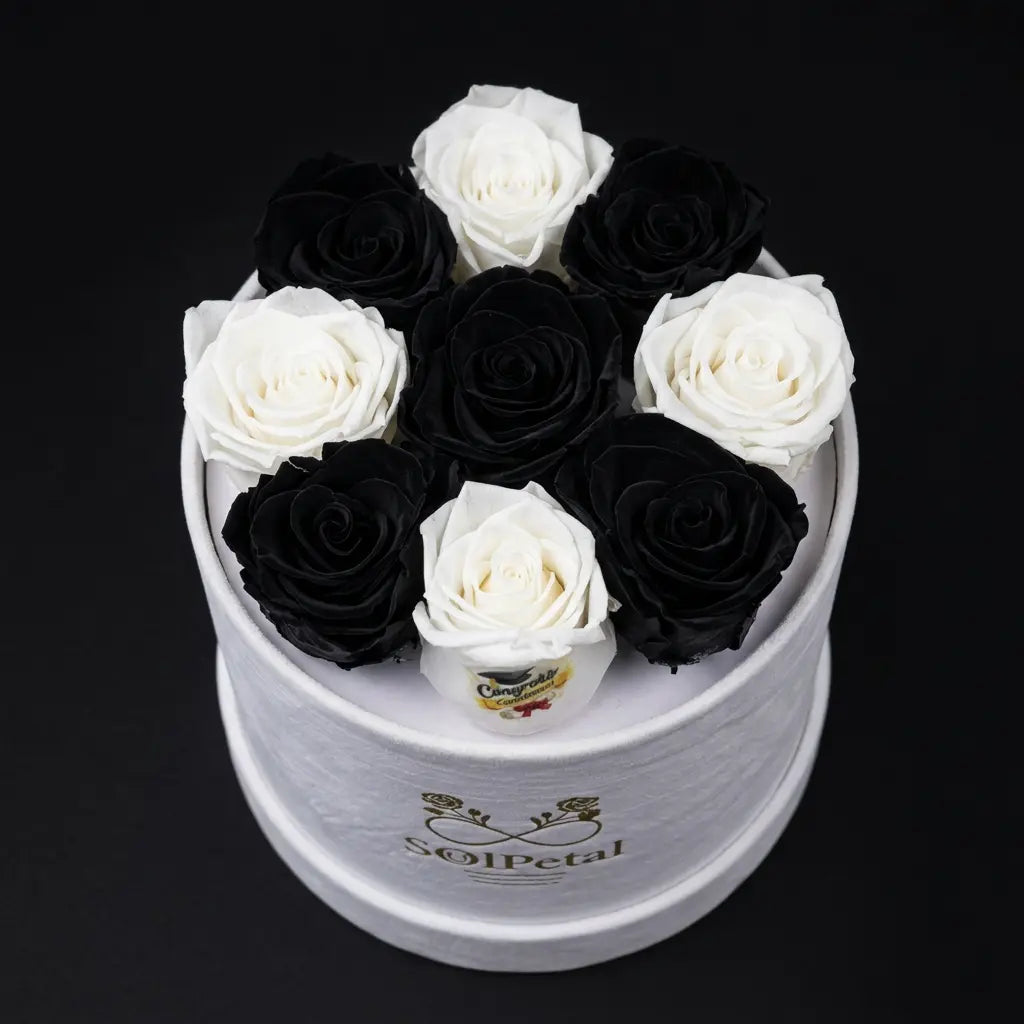White and black roses in a round white box with SolPetal branding on a black background